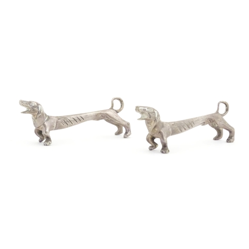 1192 - A pair of 20thC novelty knife rests modelled as dachshund dogs. Approx. 3