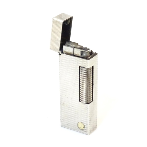 1240 - A late 20thC Dunhill rollagas pocket lighter, with chequered finish, approx 2 1/2