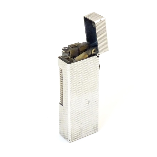 1240 - A late 20thC Dunhill rollagas pocket lighter, with chequered finish, approx 2 1/2