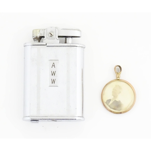 1242 - A mid 20thC Ronson Whirlwind pocket lighter, together with a 9ct gold floating locket pendant, the l... 