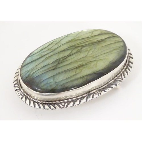 1285 - A buckle set with large labradorite style cabochon to centre. 3 1/4