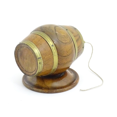 1298 - A 19thC carved walnut / treen string box modelled as a barrel with brass mounts and tap. Approx. 3