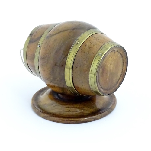 1298 - A 19thC carved walnut / treen string box modelled as a barrel with brass mounts and tap. Approx. 3