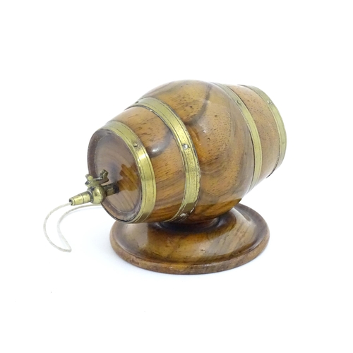 1298 - A 19thC carved walnut / treen string box modelled as a barrel with brass mounts and tap. Approx. 3