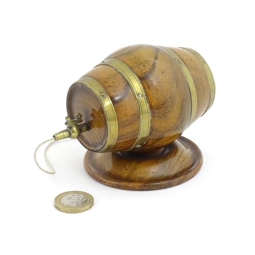 1298 - A 19thC carved walnut / treen string box modelled as a barrel with brass mounts and tap. Approx. 3