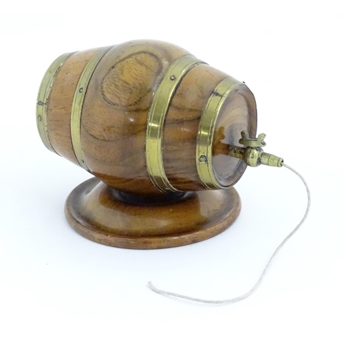 1298 - A 19thC carved walnut / treen string box modelled as a barrel with brass mounts and tap. Approx. 3