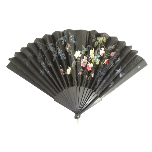 1299 - Two early 20thC fans, one bone with peacock feather detail, the other ebonised with needlework and p... 