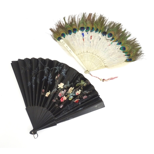 1299 - Two early 20thC fans, one bone with peacock feather detail, the other ebonised with needlework and p... 