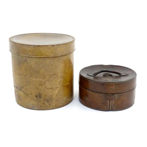 1301 - A 20thC leather collar box. Together with another leather muff box of cylindrical form. Largest appr... 