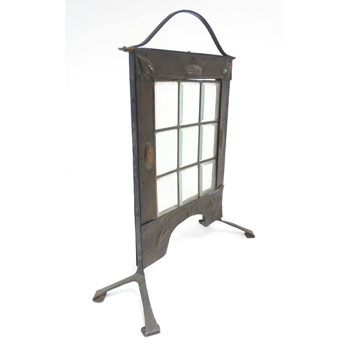 1365 - An Arts & Crafts fire screen with embossed foliate copper surround and nine glass panels to centre. ... 