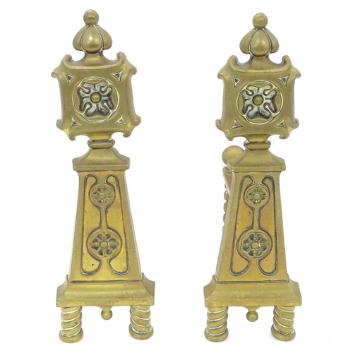 1366 - A pair of Arts & Crafts cast brass fire dogs with rosette decoration and twist detail to supports. A... 