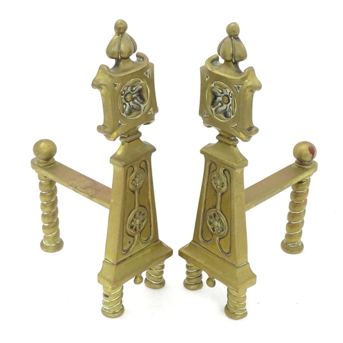 1366 - A pair of Arts & Crafts cast brass fire dogs with rosette decoration and twist detail to supports. A... 