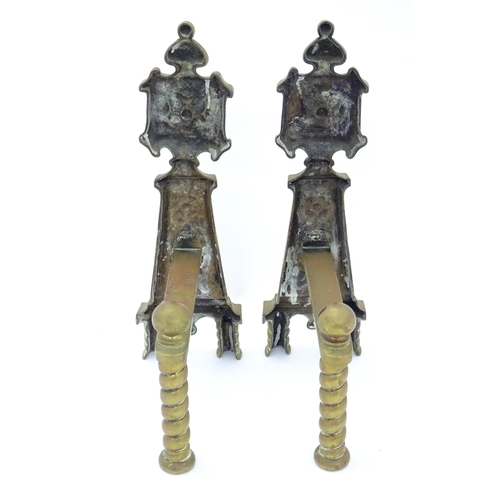 1366 - A pair of Arts & Crafts cast brass fire dogs with rosette decoration and twist detail to supports. A... 