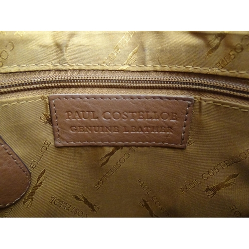 1401 - Vintage fashion / clothing: A Paul Costelloe leather cross body handbag in tan with buckle detail on... 