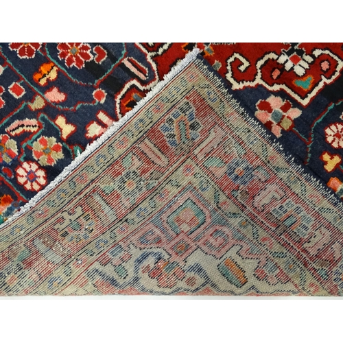 1500 - Carpet / Rug :  A Central Persian Sarouk rug  having a red, blue and cream ground with geometric flo... 