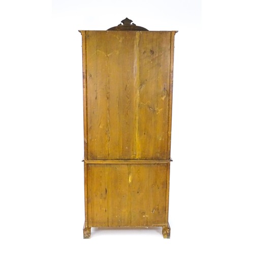 1624 - An early 20thC walnut bookcase with a carved pediment above a moulded cornice and single glazed door... 