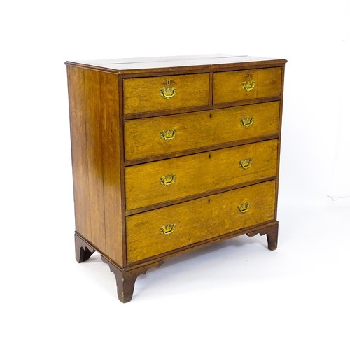 1625 - A late Georgian oak chest of drawers with a moulded top above two short over three long drawers with... 