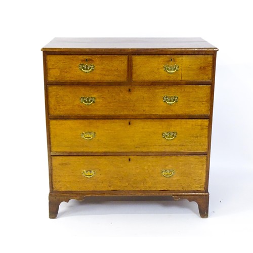 1625 - A late Georgian oak chest of drawers with a moulded top above two short over three long drawers with... 