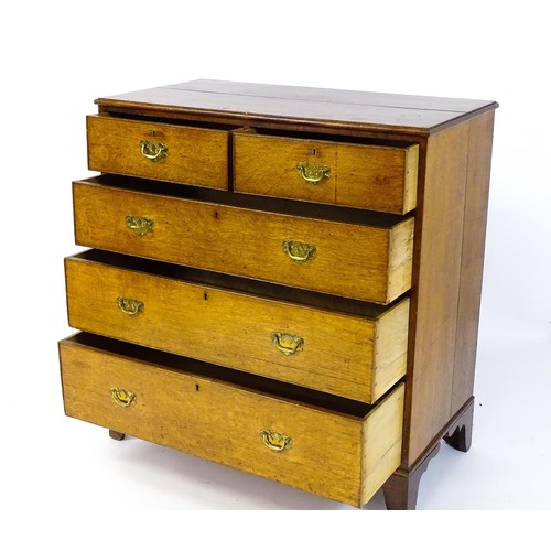 1625 - A late Georgian oak chest of drawers with a moulded top above two short over three long drawers with... 