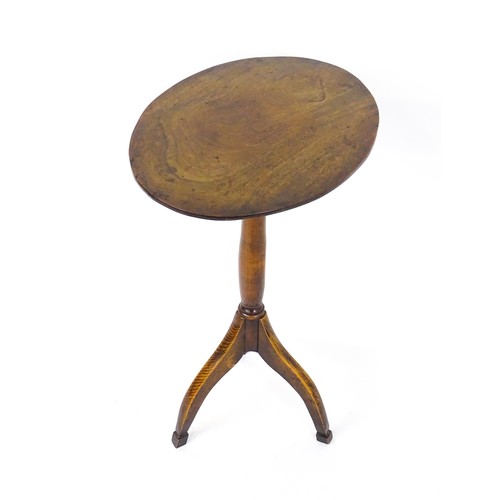 1639 - A mid 20thC mahogany tripod table with an oval top and turned tapering stem and three elongated cabr... 