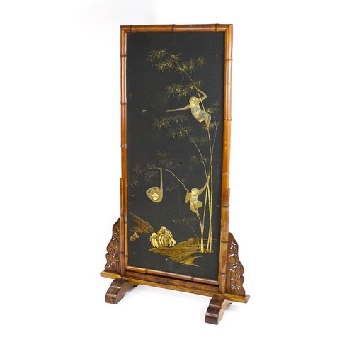 1643 - An early 20thC oriental bamboo screen, the screen having a bamboo surround with a fabric interior an... 