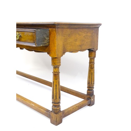 1644 - A mid 20thC oak dresser base with a moulded rectangular top above three short drawers with brass han... 