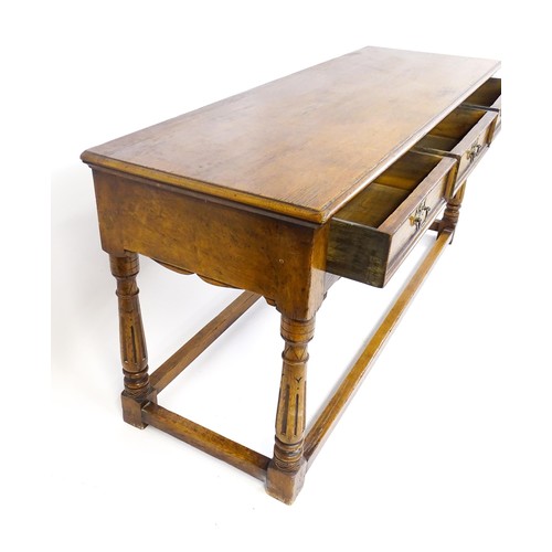 1644 - A mid 20thC oak dresser base with a moulded rectangular top above three short drawers with brass han... 