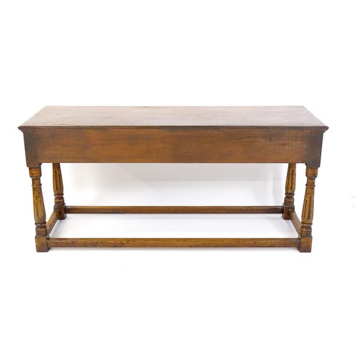 1644 - A mid 20thC oak dresser base with a moulded rectangular top above three short drawers with brass han... 