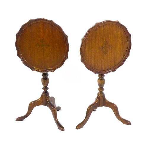 1649 - A pair of late 20thC mahogany tripod tables with pie crust tops, turned pedestals and raised on cabr... 