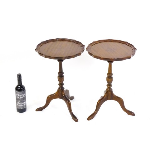 1649 - A pair of late 20thC mahogany tripod tables with pie crust tops, turned pedestals and raised on cabr... 