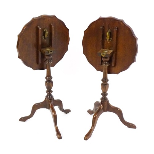 1649 - A pair of late 20thC mahogany tripod tables with pie crust tops, turned pedestals and raised on cabr... 