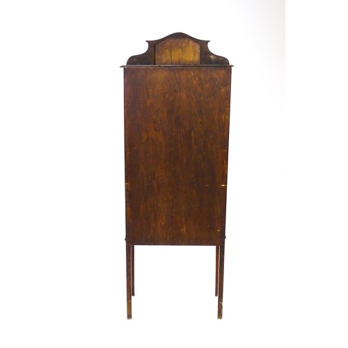 1650 - An Edwardian mahogany display cabinet with a small shaped mirrored upstand with satinwood marquetry ... 