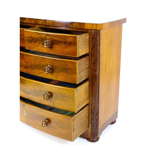 1653 - A Victorian bow fronted chest of drawers, comprising two short over three long drawers with turned w... 