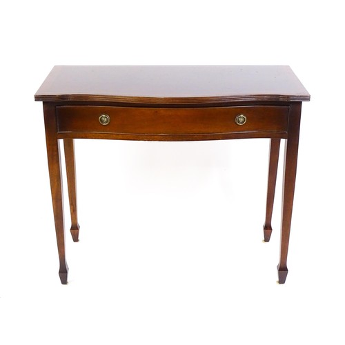 1660 - A 20thC mahogany side table, with a serpentine shaped front, reeded edge and decoratively strung top... 