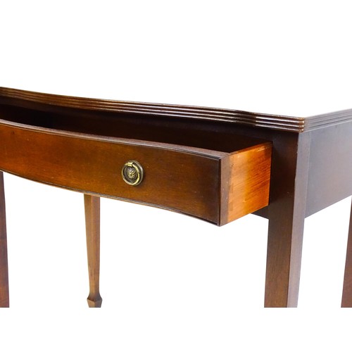 1660 - A 20thC mahogany side table, with a serpentine shaped front, reeded edge and decoratively strung top... 