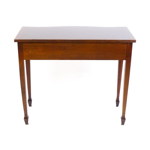 1660 - A 20thC mahogany side table, with a serpentine shaped front, reeded edge and decoratively strung top... 