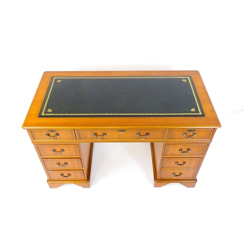 1661 - A yew wood veneered double pedestal writing desk with a gold tooled inset leather top, the base comp... 