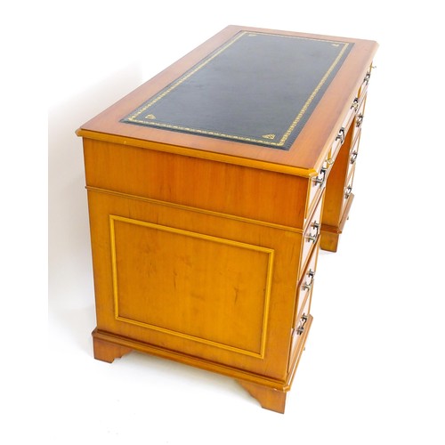 1661 - A yew wood veneered double pedestal writing desk with a gold tooled inset leather top, the base comp... 