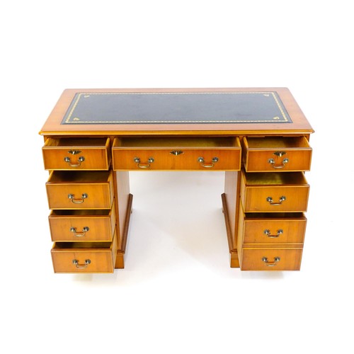 1661 - A yew wood veneered double pedestal writing desk with a gold tooled inset leather top, the base comp... 