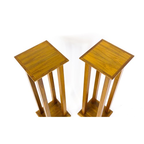 1672 - A pair of late 20thC / early 21stC walnut jardinière stands / pedestals, with square tops raised on ... 