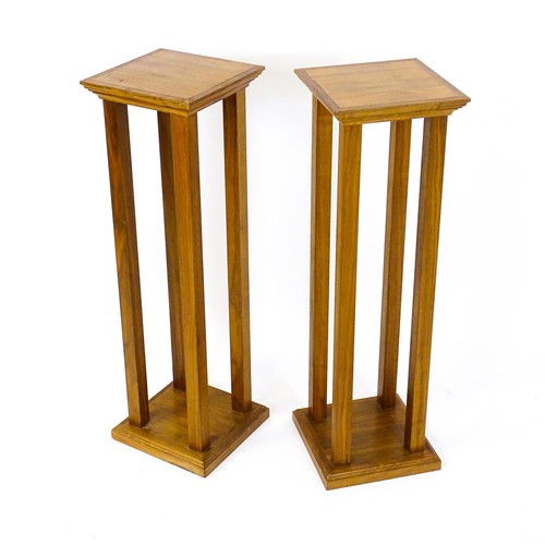 1672 - A pair of late 20thC / early 21stC walnut jardinière stands / pedestals, with square tops raised on ... 