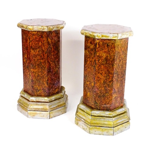 1673 - A pair of mid 20thC columns of octagonal form with silver painted capitals and bases. 18