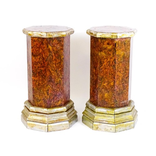 1673 - A pair of mid 20thC columns of octagonal form with silver painted capitals and bases. 18