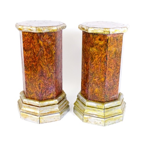 1673 - A pair of mid 20thC columns of octagonal form with silver painted capitals and bases. 18