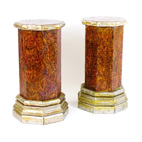 1673 - A pair of mid 20thC columns of octagonal form with silver painted capitals and bases. 18