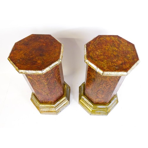 1673 - A pair of mid 20thC columns of octagonal form with silver painted capitals and bases. 18