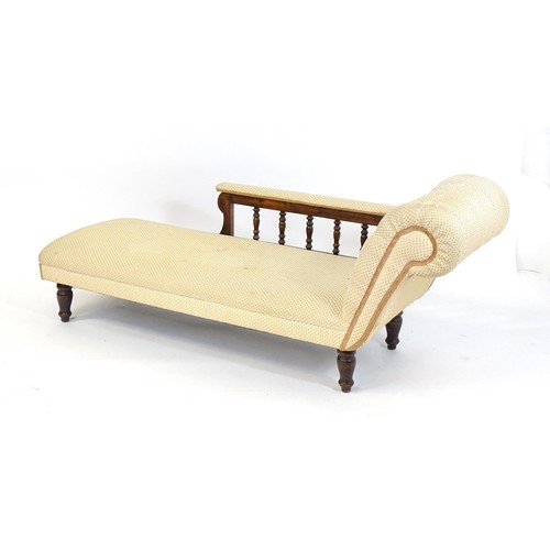 1675 - An early / mid 20thC chaise longue with a deep buttoned scrolled arm and a turned wooden gallery to ... 