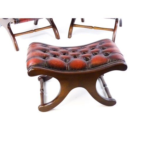 1678 - A pair of deep buttoned leather armchairs with mahogany frames, scrolled backs and scrolled arms, st... 