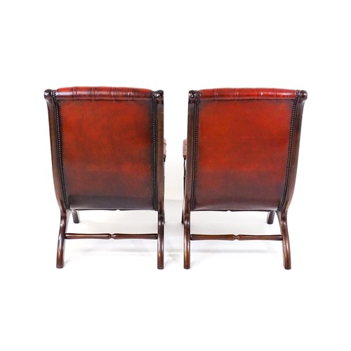 1678 - A pair of deep buttoned leather armchairs with mahogany frames, scrolled backs and scrolled arms, st... 