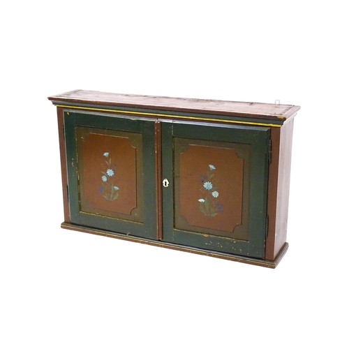 1682 - A late 19thC hanging cabinet with two panelled painted doors and opening to show a fitted interior w... 